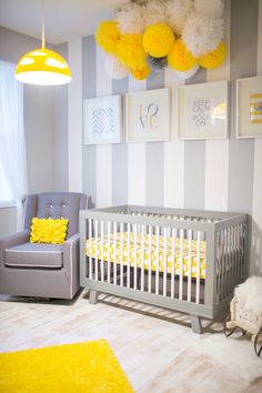 a baby's room with yellow and gray decor on the walls, including a crib