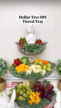 three tiered trays filled with fruit and vegetables