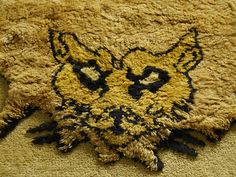 a close up of a cat rug on the floor with it's eyes open