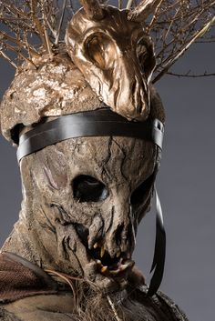 a creepy looking mask with an animal headpiece on it's face and nose