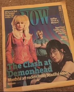 a magazine with an image of two women on the cover and one man in glasses