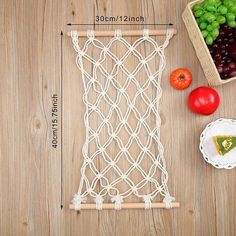 an image of fruit and vegetables on a table with measurements for the net to hold them