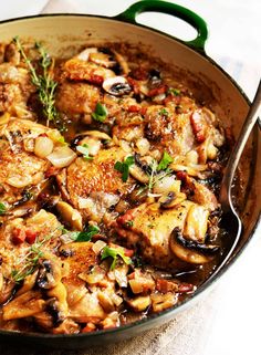 a skillet filled with chicken and mushrooms