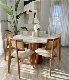 a dining room table with four chairs around it