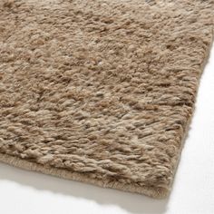 a close up view of a rug on a white surface with no one in it