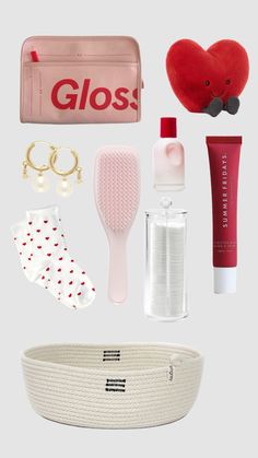 the contents of a purse and cosmetics are arranged on a white surface, including a red heart