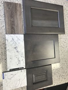 several different types of kitchen cabinet doors and drawers on the wall in a room with marble flooring