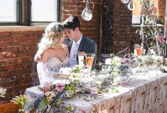 a bride and groom are sitting at a table