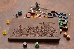 a wooden board game set with dices and pieces on the table next to it