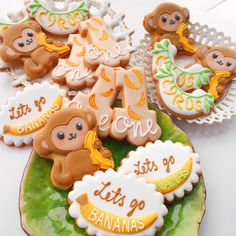 some cookies are on a green plate with white lettering and teddy bears in the middle