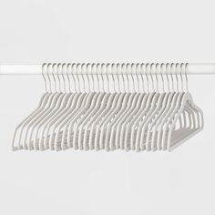 white clothes hangers are hanging on a rail