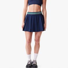 This tennis skirt, tried and tested by Lacoste players, features wide, elegant pleats, stretch fabric for freedom of movement, and Ultra Dry moisture-wicking technology. A blend of Lacoste style and technical prowess. Sporty Stretch Tennis Skirt With Pleated Waist, Blue Stretch Tennis Dress, Sporty Pleated Sports Bottoms, Athleisure Pleated Stretch Tennis Skirt, Athleisure Pleated Tennis Skirt For Sports, Sporty Pleated Tennis Skirt For Summer, Blue Stretch Tennis Skirt, Sporty Summer Tennis Skirt With Pleated Waist, Sports Stretch Pleated Skirt