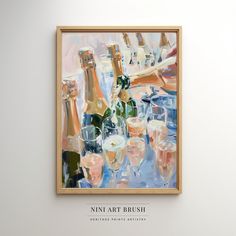 a painting hanging on the wall with wine glasses and champagne bottles in front of it