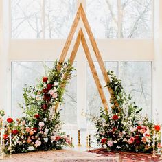 an altar with flowers and candles in front of a window