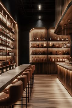 a dimly lit bar with lots of bottles on the shelves and stools in front of it