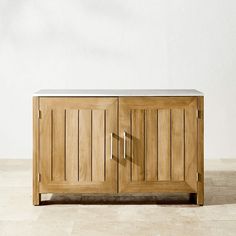 a wooden sideboard with two doors on the front and one door open to reveal a white wall