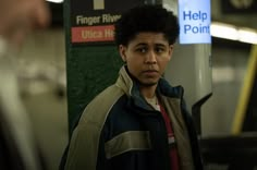 a young man standing in front of a sign that reads finger river, help point