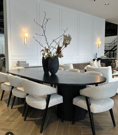 a large black table with white chairs around it