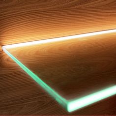 a wooden table with a green light on it