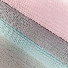 three different colored sheets are stacked on top of each other in this close up photo