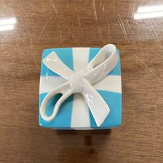 a blue and white gift box with scissors on it