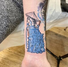 a person with a tattoo on their arm is holding an umbrella in front of them