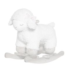 a white stuffed sheep sitting on top of a wooden sled