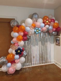 a bunch of balloons that are in the shape of a flower on a door way