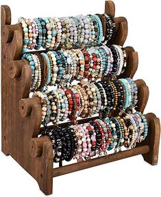 a wooden rack with bracelets on it