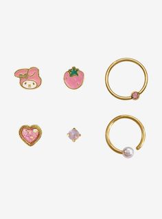 four pairs of rings with different designs and colors on them, one has a heart, the other has an earring