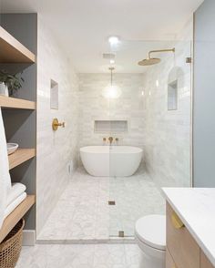 a bathroom with a tub, toilet and sink in it's center wall is shown