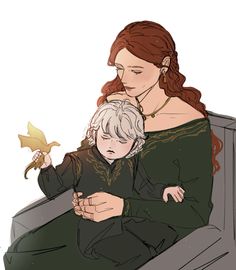 a woman holding a child in her lap