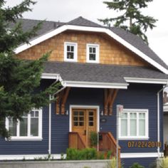 a blue house with a white bus parked in front