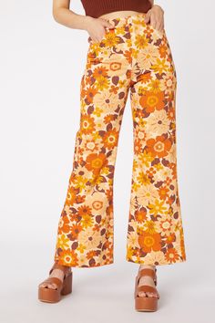 tonal floral flare jeans - a gorgeous 60’s inspired bold and vibrant floral. Super fun and very pretty!! - crafted from mid weight cotton drill - high waisted rise - full length flare leg - front zipper and button closure - side pockets - available in gold Product Code: PGFT023118 Vintage Floral Print Pants For Fall, Retro Wide Leg Floral Bottoms, Retro Wide Leg Bottoms With Floral Print, Retro Wide Leg Pants With Floral Print, Retro Spring Flare Pants, Retro Cotton Flares For Fall, Trendy Flare Pants With Floral Print, Retro High Waist Floral Print Pants, Retro High Waist Floral Pants