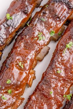 ribs covered in bbq sauce and garnished with parsley