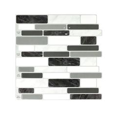 the back side of a white and black glass mosaic tile wallpaper with grey accents