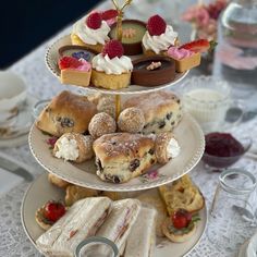 three tiered trays with pastries and desserts on them sitting on a table