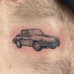 a man's chest with a tattoo of a car in the middle of it