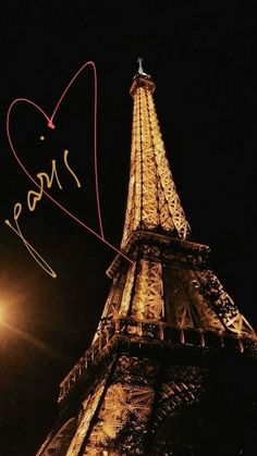 the eiffel tower is lit up at night and has writing on it that says paris