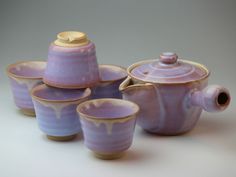 purple tea set with matching cups and saucers