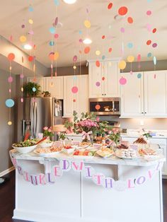 the kitchen is decorated with balloons and confetti