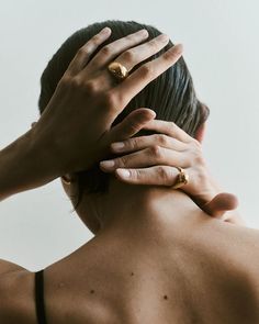 a woman with her hands on the back of her head