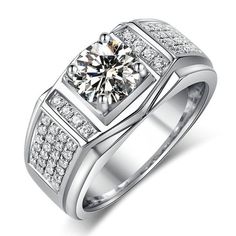 a white gold ring with diamonds on the sides and a center stone in the middle