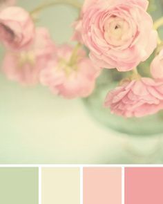 a vase filled with pink flowers sitting on top of a table next to color swatches