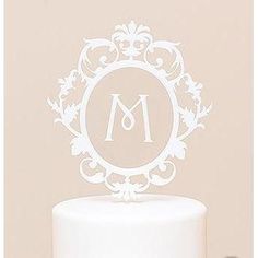 a white cake with a monogram on top