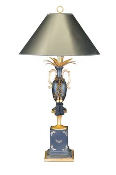 a table lamp with a blue and gold vase on it's base underneath a silver shade