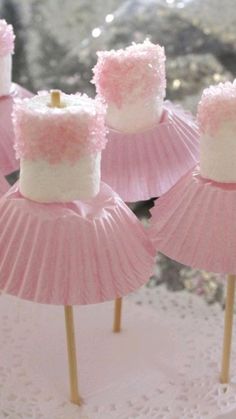 pink and white cupcakes on sticks with frosting in the shape of cakes