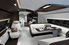 the interior of a modern jet with white and black furniture