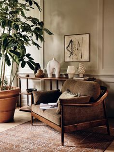 a living room filled with furniture and a potted plant