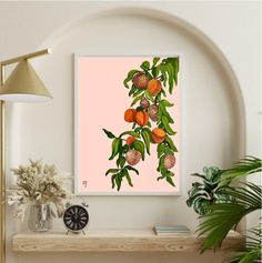 an orange tree branch with fruit on it in front of a pink background and a clock